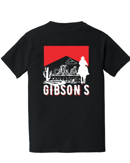 A black short-sleeve t-shirt with a large graphic on the back. The graphic features a red rectangular background with a white silhouette of a cowboy on horseback, desert mountains, cacti, and the word 'GIBSON'S' in white block letters with a red outline.