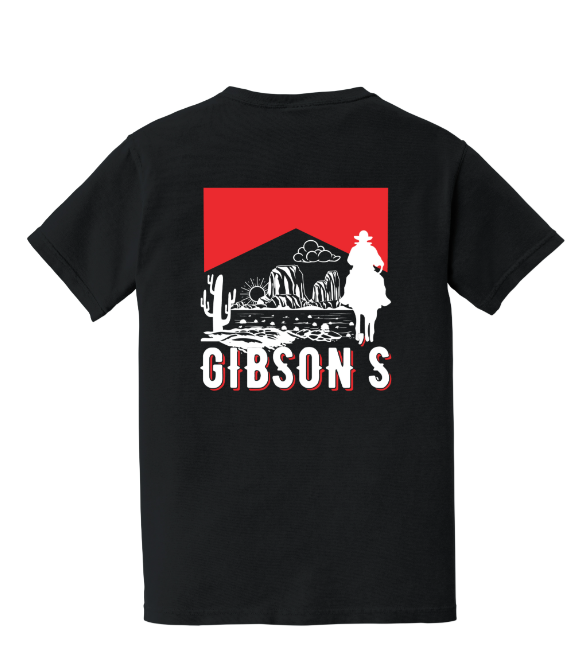 A black short-sleeve t-shirt with a large graphic on the back. The graphic features a red rectangular background with a white silhouette of a cowboy on horseback, desert mountains, cacti, and the word 'GIBSON'S' in white block letters with a red outline.