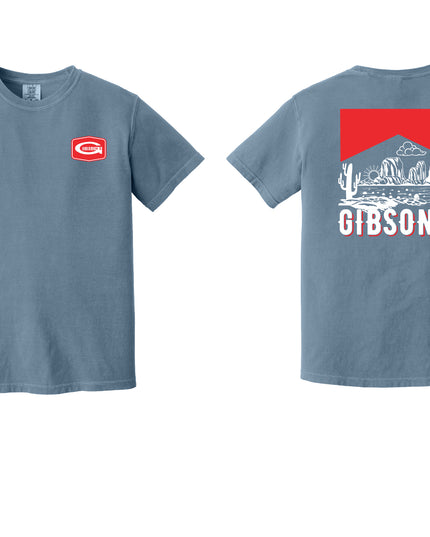 A dusty blue short-sleeve t-shirt shown from both the front and back. The front features a small red and white Gibson logo on the left chest.