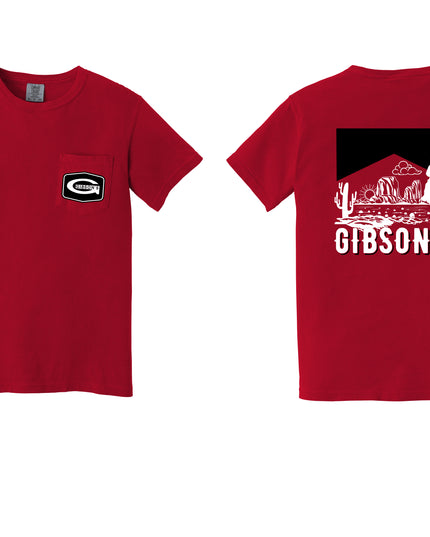 A red short-sleeve T-shirt shown from both front and back on a white background. The front has a small black-and-white chest logo, and the back features a large black graphic with white desert scenery, a cowboy silhouette, and the text 'GIBSON'S'.